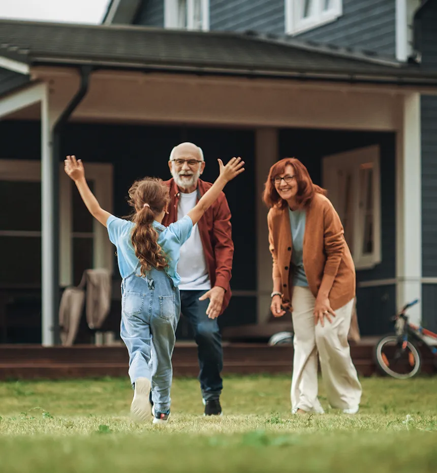 granddaughter running towards her grandparents in their yard iul policy benefits