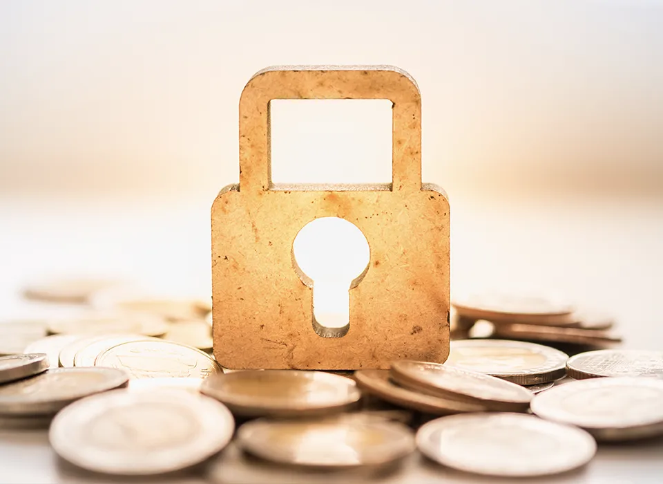 padlock on top of money coins