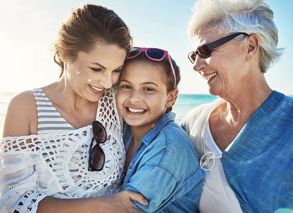 portrait of grandmother with her daughter and granddaughter at the beach legacy planning